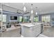 Open-concept kitchen with an island featuring bar seating, a sink, and a dishwasher at 5634 Sw 91St Ave, Ocala, FL 34481
