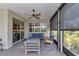 Stylish lanai with comfortable seating, ceiling fan, and view of the landscaped backyard at 5634 Sw 91St Ave, Ocala, FL 34481