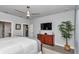 Spacious main bedroom features a modern ceiling fan, a dresser, and exterior views at 5634 Sw 91St Ave, Ocala, FL 34481