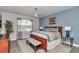 Calming main bedroom featuring a window, ceiling fan, and a cozy bench at 5634 Sw 91St Ave, Ocala, FL 34481