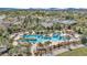 Aerial view of a resort-style pool with palm trees, lounge chairs, and nearby amenities, creating an inviting oasis at 5634 Sw 91St Ave, Ocala, FL 34481