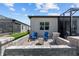 Private backyard featuring a fire pit, comfortable seating, and screened-in lanai for relaxing at 5728 Sw 90Th Court Rd, Ocala, FL 34481