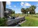 Inviting backyard with a stone fire pit, comfortable seating, and serene golf course views at 5728 Sw 90Th Court Rd, Ocala, FL 34481