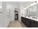 Well-lit bathroom featuring a double sink vanity, walk-in closet, and walk-in shower with a tile accent at 5728 Sw 90Th Court Rd, Ocala, FL 34481