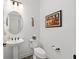 Small bathroom with a pedestal sink, toilet, and modern art on the wall at 5728 Sw 90Th Court Rd, Ocala, FL 34481
