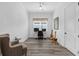 Study featuring hardwood floors, a ceiling fan, a chair and a desk with dual monitors at 5728 Sw 90Th Court Rd, Ocala, FL 34481