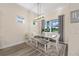 Bright dining room with table, chairs, bench, and a view of the lush backyard at 5728 Sw 90Th Court Rd, Ocala, FL 34481