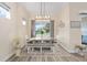 Dining room with table, seating, and view of the serene backyard and nearby lake at 5728 Sw 90Th Court Rd, Ocala, FL 34481