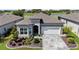 Beautiful single-story home showcases stone accents, a manicured lawn, and a water view at 5728 Sw 90Th Court Rd, Ocala, FL 34481