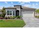 Attractive single-story home showcases stone accents, a manicured lawn, and a two-car garage with beautiful pavers at 5728 Sw 90Th Court Rd, Ocala, FL 34481