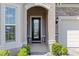 Elegant front entry with beautiful landscaping and a decorative glass door, creating a welcoming entrance at 5728 Sw 90Th Court Rd, Ocala, FL 34481