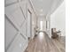Elegant hallway features stylish wood floors and decorative wall accents, leading to the main living areas at 5728 Sw 90Th Court Rd, Ocala, FL 34481