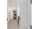 Hallway view showcasing a walk-in closet and bathroom offering a suite layout for added convenience at 5728 Sw 90Th Court Rd, Ocala, FL 34481