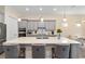 Kitchen island with seating and pendant lights, complemented by stylish countertops and cabinets at 5728 Sw 90Th Court Rd, Ocala, FL 34481