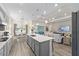 Open-concept kitchen featuring an island, stainless appliances, and seamless flow into the living and dining areas at 5728 Sw 90Th Court Rd, Ocala, FL 34481