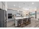 Open concept kitchen with island, stainless appliances, and view into the dining room at 5728 Sw 90Th Court Rd, Ocala, FL 34481