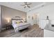 Spacious main bedroom featuring wood-look floors, a cozy color palette, and tray ceiling at 5728 Sw 90Th Court Rd, Ocala, FL 34481