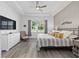 Relaxing main bedroom with tray ceiling, dresser, and a window showcasing the lake view at 5728 Sw 90Th Court Rd, Ocala, FL 34481