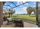 Relaxing screened porch overlooks a lush green lawn and tranquil lake, perfect for outdoor enjoyment at 5728 Sw 90Th Court Rd, Ocala, FL 34481