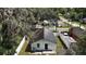 Aerial view of charming single-story home with white picket fence and lush backyard at 719 Nw 8Th St, Ocala, FL 34475