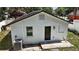 The backyard of the home features an air conditioning unit and a black door at 719 Nw 8Th St, Ocala, FL 34475