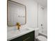 Modern bathroom featuring a white vanity with gold accents, subway tile shower, and sleek fixtures at 719 Nw 8Th St, Ocala, FL 34475