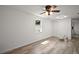 Spacious bedroom with hardwood floors, modern ceiling fan, and ample closet space at 719 Nw 8Th St, Ocala, FL 34475