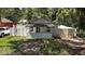 Charming single-story home featuring a quaint front porch and fenced yard with lush greenery at 719 Nw 8Th St, Ocala, FL 34475