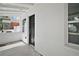 View of the front door and porch area with a white textured wall and nearby window at 719 Nw 8Th St, Ocala, FL 34475