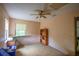 Simple bedroom with carpet flooring, ceiling fan, and one window, offering a blank canvas for your imagination at 8 Juniper Pass Way, Ocala, FL 34480