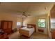 Modest main bedroom with neutral walls, carpet flooring, ceiling fan, and two windows, ready for your design ideas at 8 Juniper Pass Way, Ocala, FL 34480