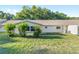 Back exterior view showcasing the lawn, windows, and door at 8710 Sw 91St Pl # B, Ocala, FL 34481