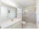 Bathroom with a shower, a toilet, and a vanity with a large mirror at 8710 Sw 91St Pl # B, Ocala, FL 34481