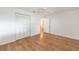 Bright bedroom features hardwood floors, ceiling fan, and closet for ample storage at 8710 Sw 91St Pl # B, Ocala, FL 34481