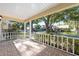 Inviting front porch with tiled flooring, white railing offering a serene outdoor view at 8710 Sw 91St Pl # B, Ocala, FL 34481