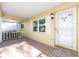 Inviting front porch with tiled flooring, white railing, and an entry door with an American flag sticker at 8710 Sw 91St Pl # B, Ocala, FL 34481