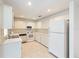 This kitchen features white appliances, ample countertop space, and recessed lighting at 8710 Sw 91St Pl # B, Ocala, FL 34481