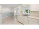 Kitchen featuring white cabinets, and a double sink, connecting to the living room at 8710 Sw 91St Pl # B, Ocala, FL 34481