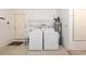 Bright laundry room includes washer, dryer, utility sink, overhead wire shelving, and a water heater at 8710 Sw 91St Pl # B, Ocala, FL 34481