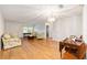 Open concept living room and dining area with hardwood floors and ample natural light at 8710 Sw 91St Pl # B, Ocala, FL 34481