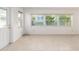 Bright living room filled with natural light from large windows overlooking the yard at 8710 Sw 91St Pl # B, Ocala, FL 34481