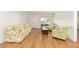 Bright living room features hardwood floors, comfortable seating, and a front door with a window at 8710 Sw 91St Pl # B, Ocala, FL 34481