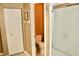 Clean bathroom with a toilet, frosted glass shower, white door, and essential fixtures at 8735 Sw 192Nd Court Rd, Dunnellon, FL 34432