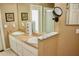 Dual sink bathroom vanity with white cabinets and a lighted makeup mirror at 8735 Sw 192Nd Court Rd, Dunnellon, FL 34432