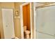 Neutral bathroom featuring a toilet, shower with glass door, and a white closet, creating a serene and functional space at 8735 Sw 192Nd Court Rd, Dunnellon, FL 34432