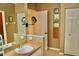 Bathroom featuring a vanity with sink, a mirrored wall cabinet, and a wall mirror with a spotlight at 8735 Sw 192Nd Court Rd, Dunnellon, FL 34432