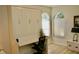 This bedroom features a built-in Murphy bed, desk, arched windows, and wood-look flooring at 8735 Sw 192Nd Court Rd, Dunnellon, FL 34432