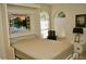 Bedroom showcases Murphy bed with a nature window view, desk with chair, and side table at 8735 Sw 192Nd Court Rd, Dunnellon, FL 34432