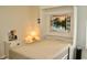 Bedroom showcases Murphy bed with scenic window view, side table, and wood-look flooring at 8735 Sw 192Nd Court Rd, Dunnellon, FL 34432