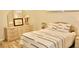 Comfortable bedroom featuring a dresser, soft natural lighting, and inviting interior decor at 8735 Sw 192Nd Court Rd, Dunnellon, FL 34432